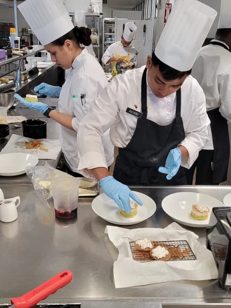 chefs cooking food in the kitchen