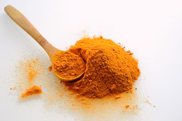 turmeric powder with a wooden ladle