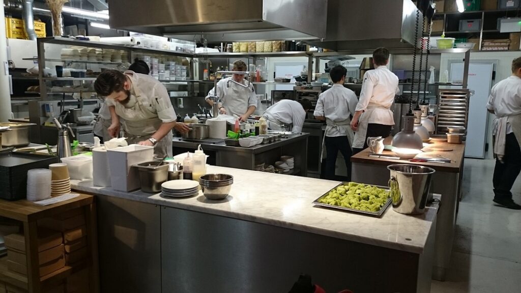 Staff in a restaurant kitchen preparing food