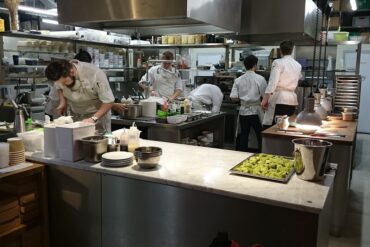 Staff in a restaurant kitchen preparing food